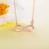 Infinity Necklace 925 Sterling Silver with rose gold finish and sparkling pendant against a soft background.