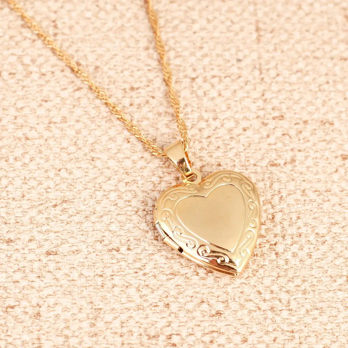 24K Gold Heart Locket Pendant Necklace with intricate design and chain, perfect for cherished memories.