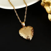 24K Gold Heart Locket Pendant Necklace displayed on a black background, highlighting its elegant design and radiant gold finish.