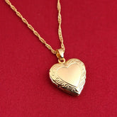 24K Gold Heart Locket Pendant Necklace on a delicate chain against a red background, showcasing its elegant design.