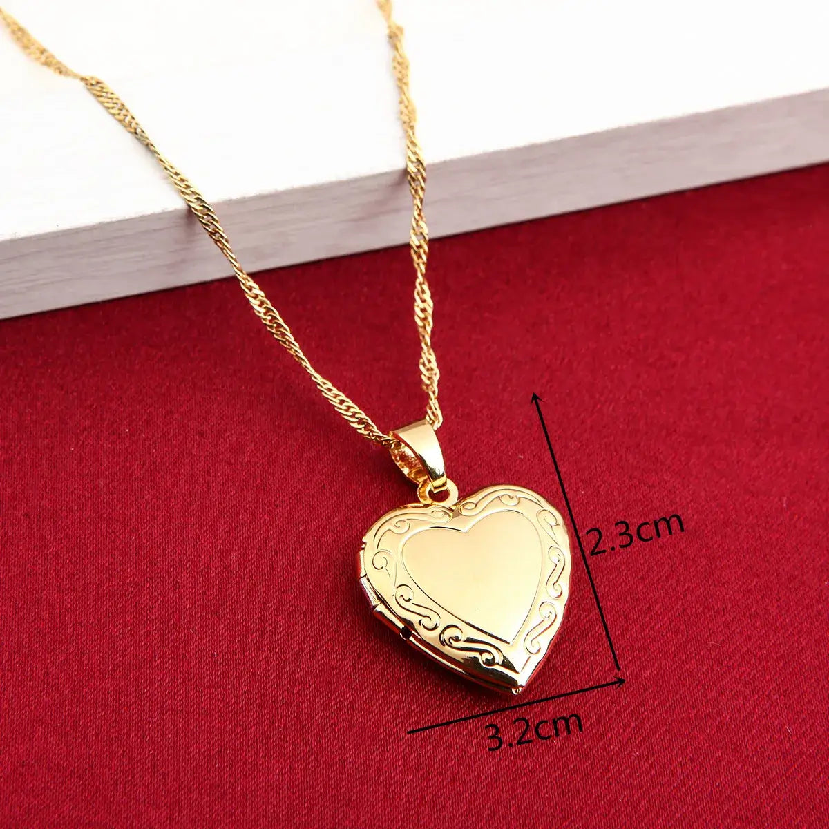 24K Gold Heart Locket Pendant Necklace displayed on a red background with dimensions shown.