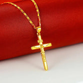 24K gold cross pendant necklace displayed on a red fabric background showcasing its elegant design.