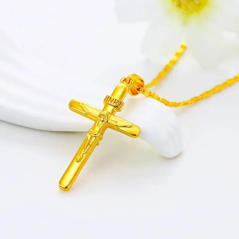 24K gold cross pendant necklace displayed on a white plate, featuring detailed design and gold-tone finish.