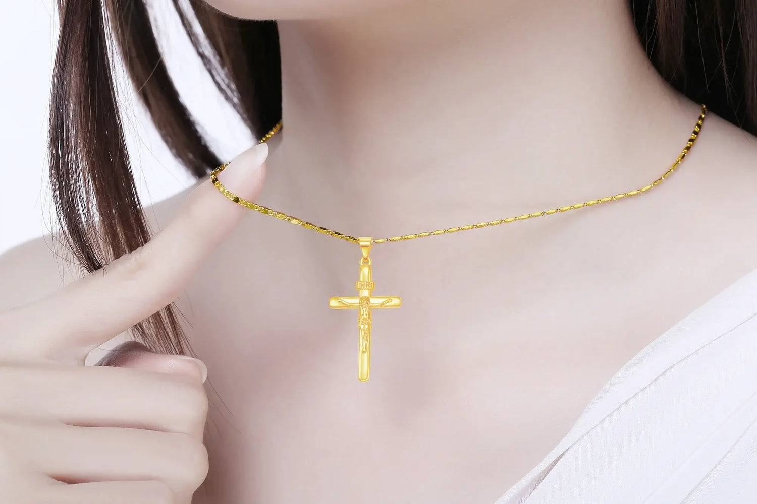 24K gold cross pendant necklace worn by a model showcasing its elegant design and polished finish.