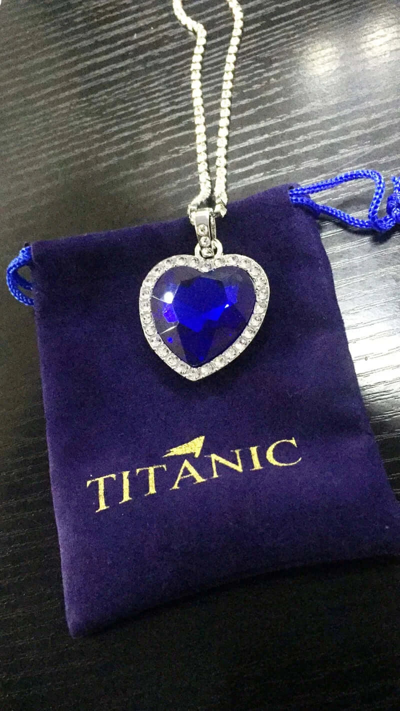 Titanic Heart of the Ocean Jewelry Set featuring a heart-shaped blue crystal pendant on a chain.